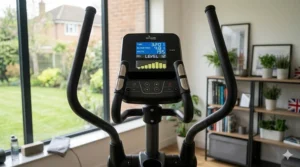 The backlit console displaying a hill climb workout programme, featuring British English terminology and clear, high-contrast data readouts.