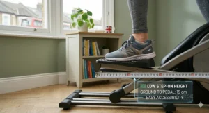 A close-up of a trainer's foot on the pedal of an elliptical, showing the low 15 cm step-on height for easy accessibility and safety.
