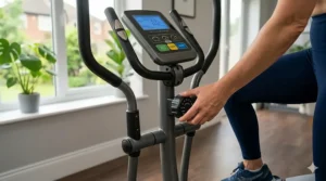 A manual tension dial on a simple cross trainer for beginners allowing for easy intensity adjustment.