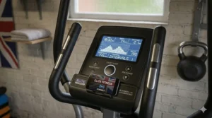 The digital display console of a studio-grade elliptical showing heart rate programmes and UK-compatible fitness app integration.