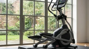 Low-angle photorealistic illustration of the cross trainer's lower frame, showcasing the complex linkage system designed for multi-axis orbital movement.