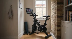 A compact spin bike with an integrated screen positioned in a space-saving corner of a UK flat.