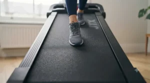 An ergonomic running deck on a compact treadmill suitable for small flat living.