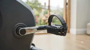 Close-up of secure, adjustable pedals with safety straps on an exercise bike.