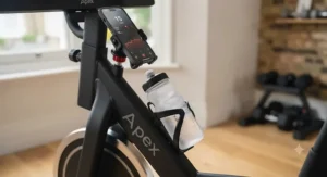 A sleek black spin bike featuring a convenient water bottle holder and device stand for home fitness sessions.