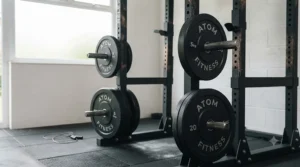 Olympic weight plate storage pegs attached to the rear of a power rack to keep a home gym tidy.